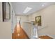 Bright hallway with skylight and hardwood floors connects the upstairs bedrooms, and stairs to the first floor at 1622 Lago Vista Blvd, Palm Harbor, FL 34685
