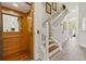 Hallway featuring a wooden elevator and staircase that leads to the home's upper level at 1622 Lago Vista Blvd, Palm Harbor, FL 34685