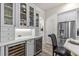 Well-designed kitchen with wine coolers, stainless steel fridge, and a quartz countertop island with seating at 1622 Lago Vista Blvd, Palm Harbor, FL 34685