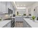 Bright kitchen features stainless appliances, white countertops, and an open layout for easy flow at 1622 Lago Vista Blvd, Palm Harbor, FL 34685