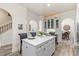 Charming kitchen island with seating; modern gray cabinets, adjacent dining area create an inviting space at 1622 Lago Vista Blvd, Palm Harbor, FL 34685