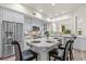 Bright kitchen features stainless appliances, quartz countertops, and a comfortable island seating area at 1622 Lago Vista Blvd, Palm Harbor, FL 34685