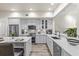 Well-lit kitchen with stainless steel appliances, white quartz countertops, and grey shaker cabinets at 1622 Lago Vista Blvd, Palm Harbor, FL 34685