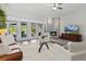 Cozy living room with corner fireplace, neutral tones, and ample natural light creating a warm atmosphere at 1622 Lago Vista Blvd, Palm Harbor, FL 34685
