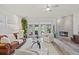 Inviting living room with stylish fireplace, comfortable seating, and views of the outdoors through large windows at 1622 Lago Vista Blvd, Palm Harbor, FL 34685