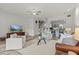 Bright living room with white walls, hardwood floors, ceiling fan, and an open-concept design at 1622 Lago Vista Blvd, Palm Harbor, FL 34685