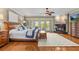 Cozy main bedroom with hardwood floors, a fireplace, and access to a balcony at 1622 Lago Vista Blvd, Palm Harbor, FL 34685