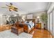 Large main bedroom with hardwood floors, ceiling fan, and a cozy seating area at 1622 Lago Vista Blvd, Palm Harbor, FL 34685