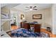 Charming home office with wooden desk, hardwood floors, and ensuite bathroom is perfect for work or relaxation at 1622 Lago Vista Blvd, Palm Harbor, FL 34685