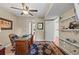 Bright office with wooden desk and hardwood floors is perfect for remote work or study and has an ensuite at 1622 Lago Vista Blvd, Palm Harbor, FL 34685