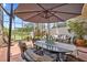Inviting outdoor patio featuring comfortable seating, shaded dining area, and picturesque water views at 1622 Lago Vista Blvd, Palm Harbor, FL 34685