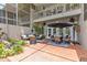 Relaxing outdoor patio offers comfortable seating, dining area and serene landscaping with a small pond at 1622 Lago Vista Blvd, Palm Harbor, FL 34685