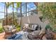 Beautiful outdoor patio with comfortable seating, mature landscaping, and tranquil water views at 1622 Lago Vista Blvd, Palm Harbor, FL 34685