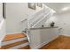 Staircase with wood treads and white risers and railings at 1622 Lago Vista Blvd, Palm Harbor, FL 34685