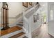 Elegant staircase with white railings and wood treads, leading to the upper level at 1622 Lago Vista Blvd, Palm Harbor, FL 34685