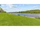 Scenic waterfront view with lush green lawn and tranquil water provides a picturesque setting at 1622 Lago Vista Blvd, Palm Harbor, FL 34685