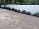 White vinyl fence in the backyard; landscape features small plants along the border at 1631 St Mary Dr, Dunedin, FL 34698