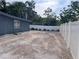 The backyard has white vinyl fencing and a gravel parking area at 1631 St Mary Dr, Dunedin, FL 34698