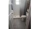 Modern bathroom with white tiled shower, gray floors, and a gray vanity with storage at 1631 St Mary Dr, Dunedin, FL 34698