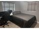 Cozy bedroom featuring a comfortable bed, sleek desk setup, and neutral color palette at 1631 St Mary Dr, Dunedin, FL 34698