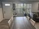 Open-concept dining room with a modern table and chairs, seamlessly connecting to the living area at 1631 St Mary Dr, Dunedin, FL 34698