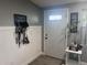 Inviting entryway with stylish decor, tiled floors, and a convenient area for organizing dog-walking gear at 1631 St Mary Dr, Dunedin, FL 34698