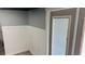 Interior room featuring wainscoting, gray paint, and a window with blinds at 1631 St Mary Dr, Dunedin, FL 34698