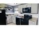 Bright kitchen with granite countertops, modern appliances, and ample cabinet space for the aspiring home chef at 1631 St Mary Dr, Dunedin, FL 34698