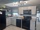 Well-lit kitchen featuring stainless steel appliances, granite countertops, and modern fixtures for a gourmet experience at 1631 St Mary Dr, Dunedin, FL 34698