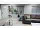 Inviting living room with neutral tones, wood-look tile floors, and large windows for ample natural light at 1631 St Mary Dr, Dunedin, FL 34698