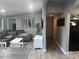 Spacious living room features comfortable seating and neutral tones, perfect for relaxing and entertaining guests at 1631 St Mary Dr, Dunedin, FL 34698