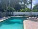 View of the backyard pool area featuring blue water and brick pavers at 1631 St Mary Dr, Dunedin, FL 34698