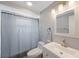 Clean bathroom featuring a shower with curtain, white vanity, and updated fixtures at 1706 Sloop Pl, Brandon, FL 33511