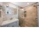 Modern bathroom with a sliding glass shower door, tiled walls, and updated fixtures at 1706 Sloop Pl, Brandon, FL 33511
