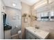 Well-lit bathroom featuring a modern vanity, decorative mirrors, and neutral color palette at 1706 Sloop Pl, Brandon, FL 33511