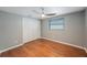 This bedroom offers wood floors, gray walls, a large closet, and a window to let in natural light at 1706 Sloop Pl, Brandon, FL 33511