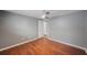 This bedroom features gray walls, wood-look flooring, and a ceiling fan for added comfort at 1706 Sloop Pl, Brandon, FL 33511