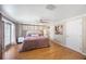 Spacious bedroom features a ceiling fan, wood floors, a window for natural light, and tasteful decor at 1706 Sloop Pl, Brandon, FL 33511