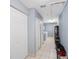 Hallway with tile floor and closets with washer/dryer in the back at 1706 Sloop Pl, Brandon, FL 33511