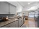 Modern kitchen with gray cabinets, granite countertops, and stainless steel appliances at 1706 Sloop Pl, Brandon, FL 33511