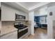 Updated kitchen with granite countertops, stainless oven range, and grey tile backsplash at 1706 Sloop Pl, Brandon, FL 33511
