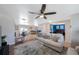 Bright living room featuring a ceiling fan, neutral tones, and comfortable seating arrangement at 1706 Sloop Pl, Brandon, FL 33511