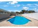 Spacious backyard showcasing a large, rectangular in-ground pool surrounded by pavers at 1706 Sloop Pl, Brandon, FL 33511