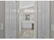 Ensuite bathroom with a shower, white cabinets, vanity, and neutral tile flooring at 18017 Palm Breeze Dr, Tampa, FL 33647