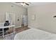 Bedroom featuring neutral walls, a ceiling fan, desk, and an ensuite bathroom at 18017 Palm Breeze Dr, Tampa, FL 33647