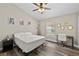 Bedroom with wood-look floors, a ceiling fan, and a bright window at 18017 Palm Breeze Dr, Tampa, FL 33647
