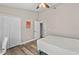 Bedroom with wood-look floors, and ensuite bathroom access through a white door at 18017 Palm Breeze Dr, Tampa, FL 33647
