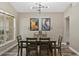 The dining room features a modern light fixture, wood flooring, and a view to the backyard at 18017 Palm Breeze Dr, Tampa, FL 33647