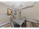 Dining room features wood floors, modern light fixture, and neutral color palette at 18017 Palm Breeze Dr, Tampa, FL 33647
