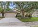 Well-maintained single-Gathering home featuring a lush green lawn at 18017 Palm Breeze Dr, Tampa, FL 33647
